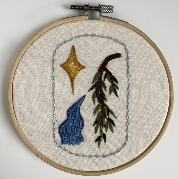 An embroidery of a star, river, and willow branch encircled by a broken chain.